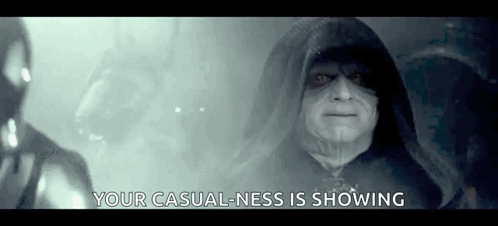 A Man In A Hooded Cloak Is Standing In A Dark Room And Says `` Your Casual Ness Is Showing '' . GIF