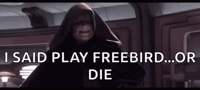 A Man In A Hooded Cloak With The Words I Said Play Freebird Or Die Above Him GIF