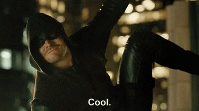 A Man In A Hooded Jacket And Mask Is Sitting On A Wall And Says Cool . GIF