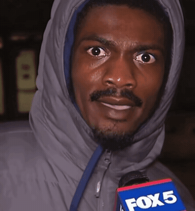 A Man In A Hooded Jacket Holds A Fox 5 Microphone In His Hand GIF
