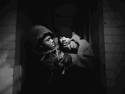 A Man In A Hooded Jacket Is Holding Another Man In A Hooded Jacket GIF