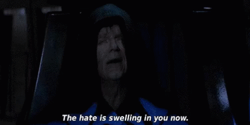 A Man In A Hooded Jacket Is Sitting In A Dark Room And Says `` The Hate Is Swelling In You Now '' . GIF