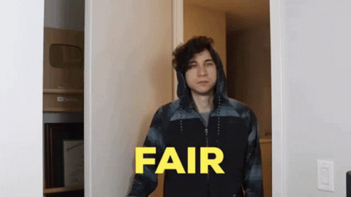 A Man In A Hooded Jacket Is Standing In A Doorway With The Word Fair In Yellow Letters GIF