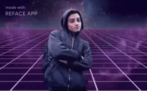 A Man In A Hooded Jacket Is Standing In Front Of A Purple Grid With The Words Hackerman Written On It GIF