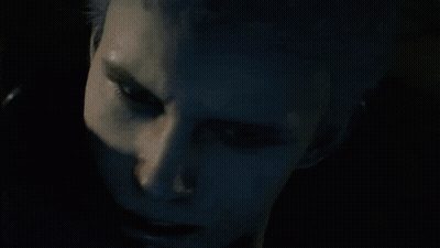 A Man In A Hooded Jacket Looks Down At Something GIF