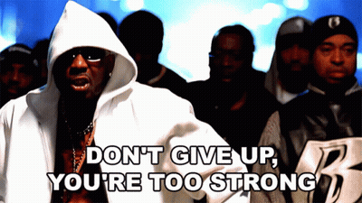 A Man In A Hooded Jacket Says " Don T Give Up You 'Re Too Strong " In Front Of A Crowd Of People GIF