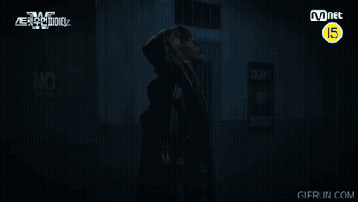 A Man In A Hooded Jacket Stands In Front Of A Sign That Says Do Not Enter GIF