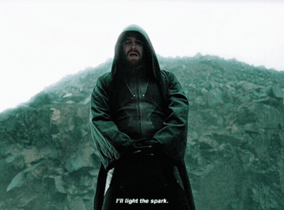 A Man In A Hooded Jacket With The Words " I 'Ll Light The Spark " Below Him GIF
