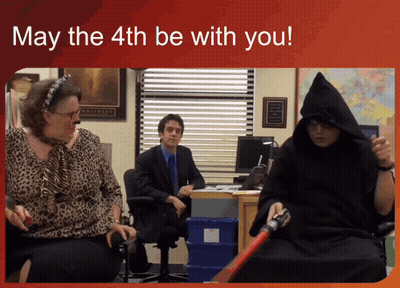 A Man In A Hooded Robe Is Holding A Darth Vader Lightsaber GIF