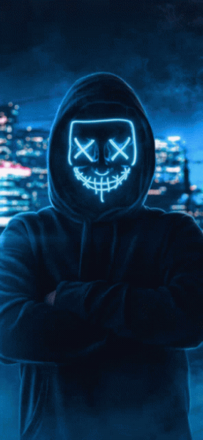 A Man In A Hooded Sweatshirt Is Holding A Purple Light In His Hands GIF