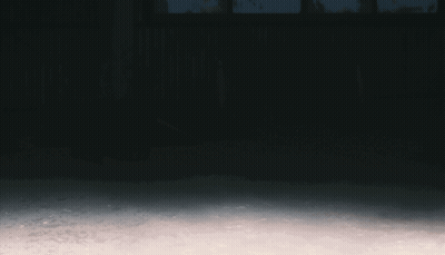 A Man In A Hooded Sweatshirt Is Running In The Dark GIF