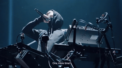 A Man In A Hooded Sweatshirt Playing A Keyboard That Says Advanc GIF