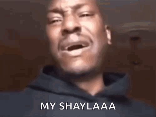 A Man In A Hoodie Is Crying With His Mouth Open And The Words `` My Shaylaa '' Written On His Face . GIF
