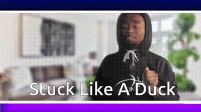 A Man In A Hoodie Is Dancing In A Living Room With The Words Stuck Like A Duck Below Him . GIF