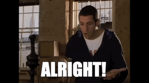 A Man In A Hoodie Is Standing In Front Of A Window And Saying `` Alright ! '' GIF