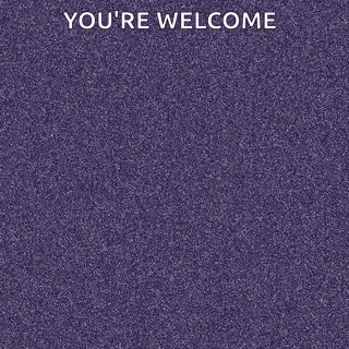 A Man In A Hoodie Is Standing With His Arms Crossed In Front Of A Purple Track . GIF