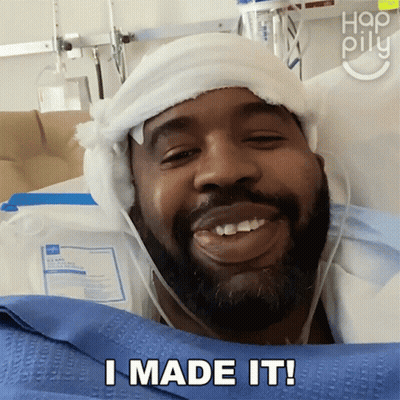 A Man In A Hospital Bed Has A Bandage On His Head And Says I Made It GIF