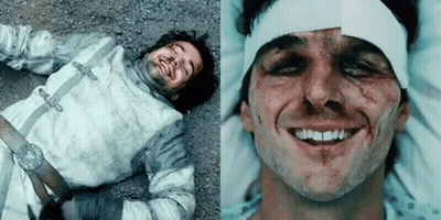 A Man In A Hospital Bed With A Bandage On His Head Is Smiling GIF