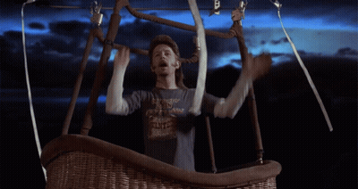 A Man In A Hot Air Balloon Wearing A Shirt That Says ' I 'M A Cowboy ' On It GIF
