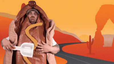 A Man In A Hot Dog Costume Holds A Shovel In His Hand GIF