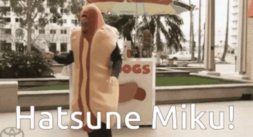 A Man In A Hot Dog Costume Is Standing In Front Of A Hot Dog Stand GIF
