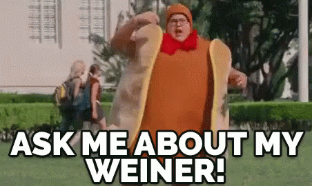 A Man In A Hot Dog Costume Is Walking In A Park And Says `` Ask Me About My Weiner '' . GIF