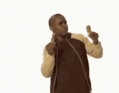 A Man In A Jacket Is Eating A Fried Chicken Wing And Giving A Thumbs Up . GIF