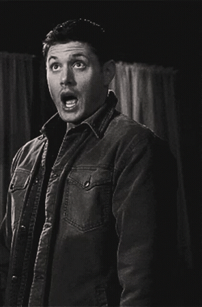 A Man In A Jacket Is Making A Surprised Face GIF