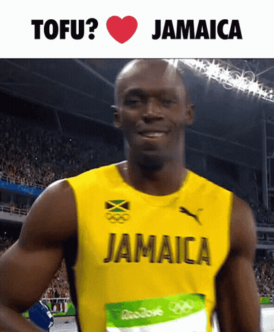 A Man In A Jamaica Jersey Is Smiling GIF