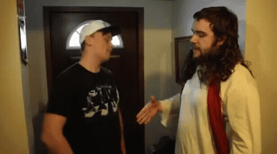 A Man In A Jesus Costume Talks To Another Man In A Black Shirt GIF