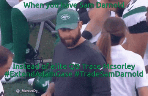 A Man In A Jets Hat Stands In Front Of A Group Of Players GIF