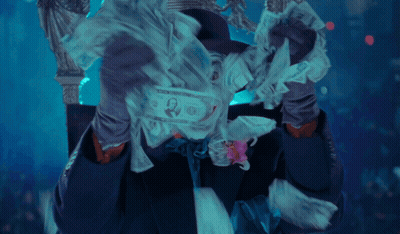 A Man In A Joker Costume With A Flower In His Tie GIF