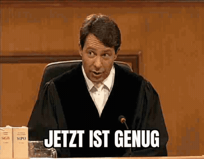 A Man In A Judge 'S Robe Is Sitting In Front Of A Microphone And Says Jetzt Ist Genug GIF