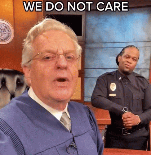 A Man In A Judge 'S Robe Says " We Do Not Care " In Front Of A Police Officer GIF