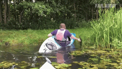 A Man In A Kayak Wearing A Pink Tank Top That Says Bank Scouts GIF