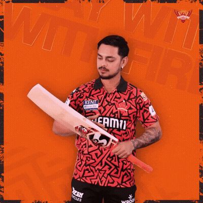 A Man In A Kent Shirt Holds A Cricket Bat In Front Of An Orange Background GIF