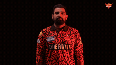 A Man In A Kent Shirt Is Holding A Ball GIF