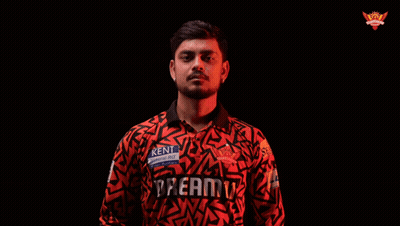 A Man In A Kent Shirt Is Holding A Bat GIF