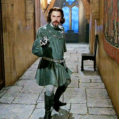 A Man In A Kilt Is Holding A Sword GIF