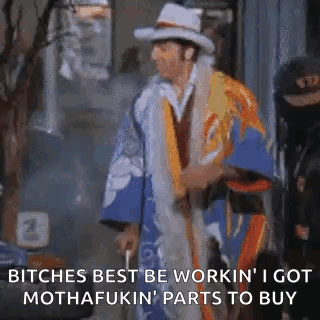 A Man In A Kimono And Hat Is Standing On A Sidewalk . GIF