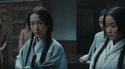 A Man In A Kimono Holds Out His Hand Towards A Group Of Men GIF