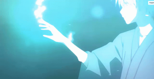 A Man In A Kimono Is Holding Something In His Hand GIF