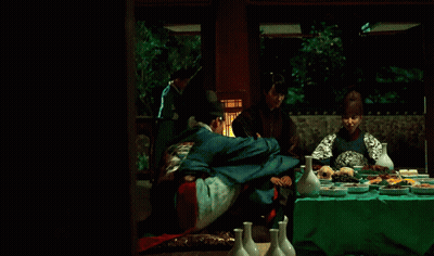 A Man In A Kimono Is Hugging Another Man In A Blue Jacket GIF