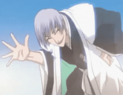 A Man In A Kimono Is Waving His Hand In The Air . GIF