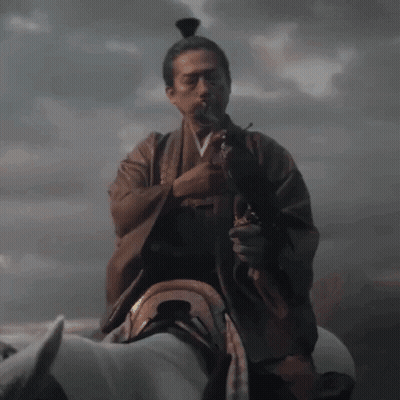 A Man In A Kimono With A Sword In His Hand GIF