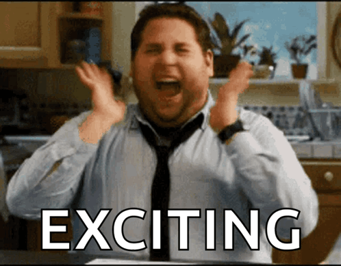 A Man In A Kitchen With Exciting Written On The Screen GIF