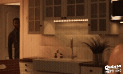 A Man In A Kitchen With Quinta Everything Written On The Bottom GIF