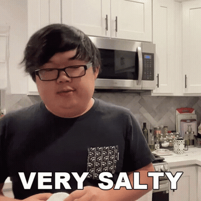 A Man In A Kitchen With The Words Very Salty On His Shirt GIF