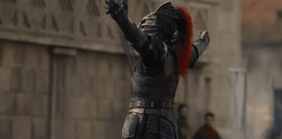 A Man In A Knight 'S Armor Has His Arms Outstretched In The Air GIF