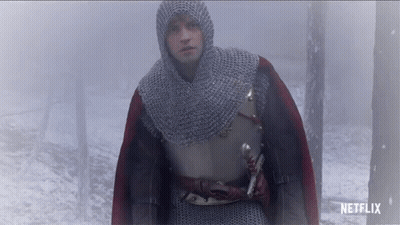 A Man In A Knight 'S Armor Is Walking Through A Foggy Forest With A Netflix Logo Behind Him GIF